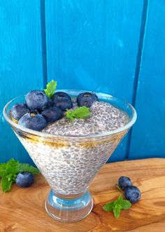 blueberries and oatmeal in a glass on a wooden table