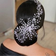 the back of a woman's head wearing a hair comb with flowers on it