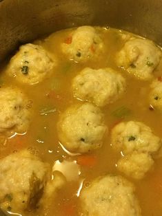 a pot filled with soup and meatballs in it