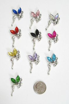 YOU ARE BIDDING ON 10 NEW RHINESTONE FAIRY/TINKERBELL"   CHARMS/PENDANTS.  YOU WILL RECEIVE A TOTAL OF 10- ONE OF EACH COLOR AS SHOWN.   THESE CHARMS ARE FROM A PET/SMOKE FREE HOME AND OH SO CUTE--I HAVE PUT A DIME IN THE PHOTO SO YOU CAN SEE THE SIZE OF EACH CHARM.  THESE ARE PERFECT FOR JEWELRY MAKING OR SCRAPBOOKING AND WHAT A GREAT PRICE.  THERE ARE NO JUMP RINGS WITH THESE CHARMS.   PROJECTS!  I WILL COMBINE SHIPPING--ONLY $.15 SHIPPING FOR EACH ADDITIONAL SET OF CHARMS PURCHASED.  ENJOY FR Fairy Tinkerbell, Fairy Charms, Disney Jewelry, Jewelry Making Charms, Jump Rings, Bead Crafts, Beading, Charms, Charm Bracelet