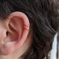 This is a lightweight adjustable ear cuff!  It fits comfortably around the outside ridge of the ear, and piercings are not needed for this cuff. This cuff features a swirl at the end to make it more comfortable and less pokey. Ear cuffs are easy to put on and off. Slip the ear cuff around the top of the ear and slide it to the desired loaction. This ear cuff can be adjusted for your comfort by gently squeezing or stretching as needed. Adjustable Single Ear Cuff For Everyday Wear, Adjustable Hypoallergenic Ear Cuff For Everyday Wear, Everyday Gold Ear Cuff With Ear Wire, Minimalist Adjustable Pierced Ear Cuff, Hypoallergenic Adjustable Ear Cuff For Everyday, Minimalist Pierced Adjustable Ear Cuff, Adjustable Gold Clip-on Ear Cuff, Gold Metal Ear Cuff Nickel-free, Elegant Adjustable Gold-plated Ear Cuff