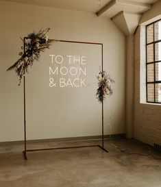 a room with a sign that says to the moon and back