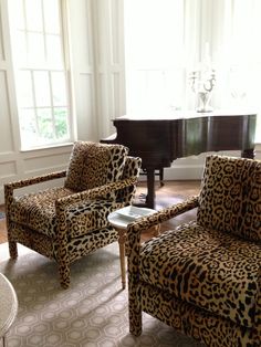 a living room filled with furniture and a piano