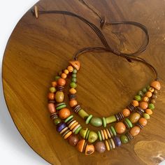 CHUNKY LAYER TAGUA NUT NECKLACE Our uniquely handcrafted Chunky Layer Tagua Nut Necklace is a one-of-a-kind accessory that celebrates the beauty of nature and craftsmanship. Each necklace holds an average of 120 uniquely and meticulously handcrafted beads from all-natural Tagua Nut and other seeds and materials such as açai and coconut, making every piece a unique work of art. Our Chunky Layer Tagua Nut Necklace blends rustic charm and and modern style complete with striking color hues and natur Handmade Artisan Necklaces In Natural Color, Unique Handmade Natural Color Necklaces, Unique Handmade Natural Necklaces, Unique Handmade Necklaces, Unique Natural Color Handcrafted Necklace, Bohemian Beaded Necklaces As Gift, Bohemian Beaded Necklace With Natural Variations, Earthy Style Necklace With Natural Variations For Gift, Earthy Necklace With Natural Variations For Gifts