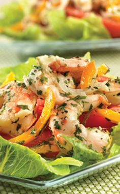 lettuce with shrimp and peppers in it on a plate