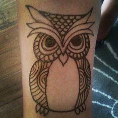 an owl tattoo is shown on the leg