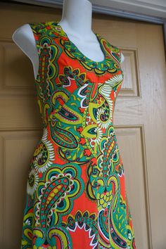 "Vintage 1970s maxi dress. No tags fits like a Medium. In good vintage condition. Please see measurements. Measurements taken across front laid flat - stretchy 19\" across front armpit to armpit 15\" across front of empire waist 24\" across hips 56\" length" Fitted Sleeveless Maxi Dress With Vibrant Print, Retro V-neck Lined Maxi Dress, Fitted Vintage Print Dress Inspired By 70s, Fitted 70s Inspired Dress With Vintage Print, Fitted Dress With Vintage Print In 70s Style, Retro Spring Maxi Dress With Vibrant Print, Retro Summer Maxi Dress With Vibrant Print, 1970s Fitted Sleeveless Maxi Dress, 1970s Maxi Dress With Vintage Print