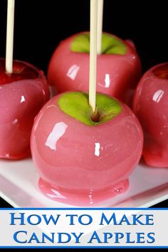 four candy apples on a plate with toothpicks sticking out of the top one