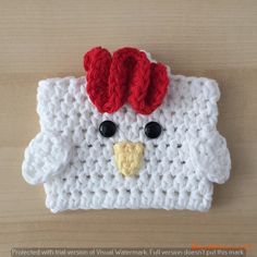 a close up of a knitted object with a chicken face on it's side