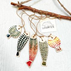 four ceramic fish ornaments hanging from twine