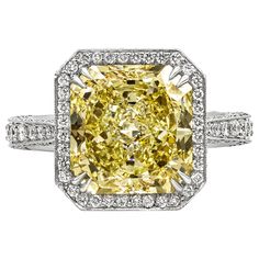 A vintage-looking engagement ring style showcasing a 5.27 carat radiant cut yellow diamond, certified by GIA as Fancy Light Yellow color, VS1 clarity. Surrounding the center diamond is a brilliant diamond halo in a diamond encrusted shank. Accent diamonds weigh 0.65 carats total. Finished with milgrain edges for that antique look and feel. Made in platinum. Size 6 Style available in different price ranges. Prices are based on your selection. Please contact us for more information. Cushion Diamond Ring, Yellow Diamonds Engagement, Cushion Cut Diamond Ring, Vintage Style Engagement Rings, Engagement Rings Vintage Halo, Platinum Diamond Engagement Rings, Yellow Diamond Rings, Fancy Yellow Diamond, Modern Engagement Rings