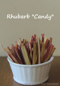 a white bowl filled with rhubarb'candy on top of a wooden table