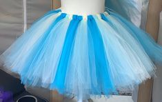 This Beautiful and adorable all year round  Teenage and adult tutus will add a lovely touch to your wardrobe collection. This blue and cream color  combine makes this tutus a delight to wear! Handmade from 100% Polyester Tulle Fabric. Comes with 1 inch satin covered elastic Waistband. Light weight and well Crafted.  Can be used  as Casual or Formal Wear. These  length are available in your favorite colors as  well. Please leave  a note for the seller in the message box provided. Thanks Blue Fitted Tulle Tutu Dress, Green Tutu, Womens Skirts, Newborn Headbands, Message Box, Flag Colors, Tulle Fabric, Formal Wear, Cream Color