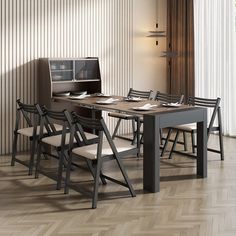 a dining room table with chairs and a computer monitor