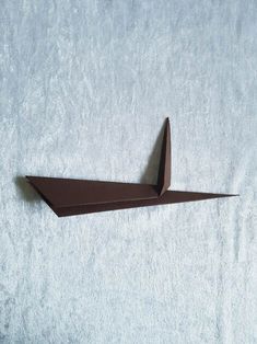 an origami paper boat on a white background