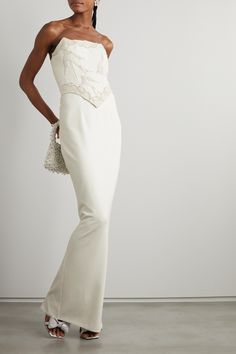 Clio Peppiatt's column skirt is an elegant choice for the modern bride looking for city-chic separates that can be worn well beyond the special day. It's made from ivory crepe enriched with four-way stretch and falls to a maxi length. Style it with the designer's coordinating corset and a beaded bag.