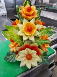 an arrangement of flowers made out of fruit