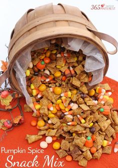 pumpkin spice snack mix in a bucket on top of a pile of corn and candy