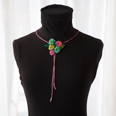 This unique and stylish fabric tie necklace is a true statement piece of jewelry, handmade with love. The necklace is crafted from recycled vintage fabrics, giving it a touch of nostalgia and sustainability.  The floral pattern adds a charming and feminine touch to any outfit, making it equally suitable for casual style business suits or party dresses. Its lightweight design ensures comfort throughout the day, and the adjustable height allows for a perfect fit. Not only is this necklace a beautiful fashion accessory, but it also carries a story of upcycling and repurposing. By wearing this necklace, you are making a conscious choice to support sustainable fashion and reduce waste.  Add a personalized touch to your style with this versatile and eye-catching necklace. It's the perfect additi One-of-a-kind Adjustable Choker Necklace, One Of A Kind Adjustable Choker Necklace, Multicolor Lariat Necklace For Gift, Handmade Multicolor Lariat Necklace As Gift, Handmade Multicolor Lariat Necklace Gift, Handmade Artisan Lariat Necklace For Gift, Adjustable Beaded Necklace With Flower Pendant, Handmade Pink Lariat Jewelry, Handmade Long Fusion Necklace