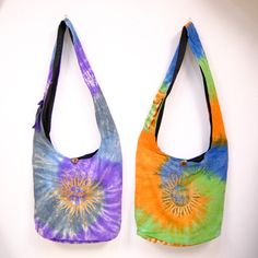 Tie Dye Cotton Messenger Bag, Whimsical Boho Crossbody Bag, Colorful Festival Sling, Hippie Hobo Bag, Colorful Beach Crossbody Handmade Bag  Unlock your inner free-spirit with this handmade, unisex messenger bag. Featuring a classic, tie-dye sun design and whimsical style, it's perfect for festivals, travelers, and anyone who loves the carefree and bohemian look. Handmade in Nepal Material: Organic Cotton This cotton messenger bag has a zipper closure and one smaller internal zip pocket Cotton inner lining One outer Strap Pocket with a velcro fastener where you can store your phone width: Approx. 16 inches Height: Approx. 15 inches Total Bag Length: Approx. 38 inches **ETHICALLY SOURCED **FAIRTRADE **SUSTAINABLE FASHION Multicolor Shoulder Beach Bag For Festivals, Festival Multicolor Shoulder Beach Bag, Multicolor Festival Shoulder Beach Bag, Multicolor Hippie Bag With Adjustable Strap, Hippie Multicolor Bag With Adjustable Strap, Hippie Multicolor Bags For Festival, Hippie Multicolor Shoulder Bag With Adjustable Strap, Hippie Multicolor Shoulder Bag For Festival, Multicolor Hippie Bag For Festivals