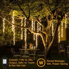 an outdoor table and chairs with lights hanging from the trees