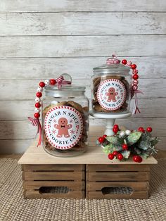 two jars filled with cookies sitting on top of a wooden table