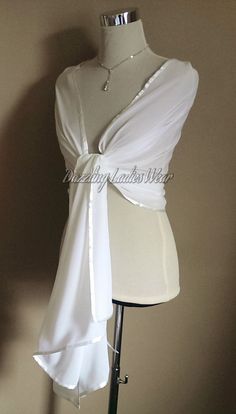 "All of our items are handmade and unique to our company.  Beautiful light ivory/off white chiffon shawls with a satin trim Perfect to drape or wrap around your arms and shoulders.  Fantastic for weddings and formal occasions! Approximate measurements 78\" Long  27\" Wide Lots of other styles/colours available, click on link below to view my Etsy shop -  https://www.etsy.com/uk/shop/dazzlingladieswear?ref=hdr_shop_menu Composition - 100% polyester Due to different screen settings, colours can appear different on different screens, therefore the shade of the item in person, may vary slightly in person to the shade you see on screen." Elegant White Wedding Dress For Ceremony, Elegant White Bridal Accessories For Wedding, Elegant White Formal Veil, White Fitted Veil For Formal Occasions, Formal Fitted White Veil, White Ceremony Veil, Elegant White Bridal Accessories For Mother Of The Bride, Elegant White Veil For Ceremony, Elegant White Ceremony Veil