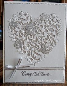 a white card with flowers and ribbon on the front, says congratulations design by carol longener