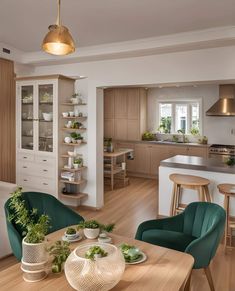 an open concept kitchen and dining area with wood flooring, white walls and cabinets