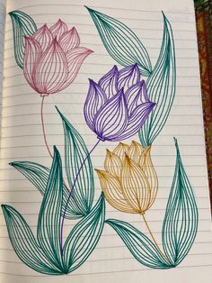 an open notebook with some flowers drawn on it