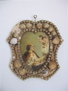 there is a painting on the wall with shells around it