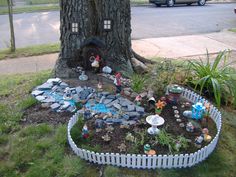 a fairy garden in front of a tree