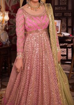 Introducing our New collection 'Chandni Raatein' by Asim Jofa designed to make you look and feel your best. Transformed into a living petal, this pink ensemble is a fairytale garden in bloom. The embroidered Peshwas, a delicate flower unfurling, is adorned with a cascade of light gold dewdrop-like sequins, coupled with 5mm and 9mm gold sequins amidst the intricate amalgam of gold zari and beige threads, weaving a glittering path guiding the gaze gently toward a blooming pink rose. The green embroidered dupatta, a verdant oasis, concludes this dreamlike story with a flourish. Embroidered Front Bodice on Chiffon Embroidered Back Bodice on Chiffon Embroidered Border for Front and Back Neckline, Bodice Hem and Armhole on Chiffon Embroidered Kalis for Peshwas on Chiffon Embroidered Border for H Pink Sharara For Reception Navratri, Pink Sharara For Reception And Navratri, Pink Designer Wear Unstitched Sharara, Designer Pink Sharara For Eid, Pink Churidar With Dabka Work For Reception, Pink Dabka Work Churidar For Reception, Pink Semi-stitched Anarkali Set For Festivals, Elegant Pink Churidar For Reception, Designer Pink Anarkali Set For Diwali