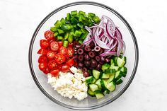 a glass bowl filled with different types of vegetables