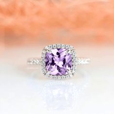 Gorgeous cushion cut amethyst ring is made of 925 solid sterling silver, making a simple but elegant statement piece. This ring is perfect to wear as engagement ring, promise ring, birthstone ring, or statement piece. ►Average band width: 2 mm ►True to size. ►Your sterling silver ring will not turn green itself and will not cause your skin to turn green. Center Stone: Amethyst Shape: Cushion Size: 8.0 x 8.0 mm Carat Weight: 2.5 ct. (approx.) Gemstone creation: Natural Hardness: 7 (Mohs scale) Ac Amethyst Halo Rings For Promise, Fine Jewelry Amethyst Halo Ring Gift, Fine Jewelry Amethyst Halo Promise Ring, Fine Jewelry Amethyst Ring With Halo For Promise, Purple Diamond Ring With Halo Setting For Anniversary, Purple Halo Ring For Anniversary, Formal Lavender Rings With Halo Setting, Classic Amethyst Promise Ring With Center Stone, Cushion Cut Amethyst Ring With Center Stone For Wedding