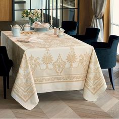 a dining room table is set with two cups and saucers