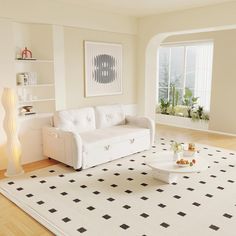 a living room with white furniture and black and white rugs on the hardwood floor