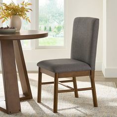 a dining room table with two chairs next to it