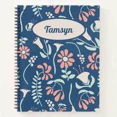 a blue notebook with flowers and the word tamsyn on it