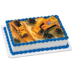 a birthday cake decorated with construction vehicles