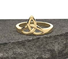 Celtic Triquetra Knot Ring Silver, Trinity Knot Promise Ring, Triangular Knot Engagement Ring, Women's Celtic Ring, Christmas Gift For Her Product Details: Gemstone : N/A Metal : 925 Sterling Silver, 14k Gold Finish Item : Ring Approx Weight : 3 grams ABOUT CELTIC: This Celtic Trinity Knot Ring comes in Gold and Sterling Silver. The current selection is made from Gold Coated Sterling Silver. Max Ring Width 10 mm. The Trinity Knot is the most well-known Celtic design. It represents eternity and continuity. The three knots can represent the past, present and future of the relationship. Celtic Designs have been around since ancient times and have long been applied to create fine art. Their distinctive patterns have appeared on stone, metalwork, in jewelery and on magnificent illuminated manus Knot Promise Ring, Knot Engagement Ring, Trinity Knot Ring, Celtic Triquetra, Celtic Ring, Celtic Trinity Knot, Celtic Design, Trinity Knot, Celtic Rings