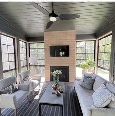 a living room filled with furniture and a flat screen tv mounted on the wall above a fireplace