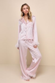 With the Lulus Dreamiest Delight Light Pink Satin Feather Two-Piece Pajama Set, you'll look so good that you'll never want to go to bed! This sleek pajama set has a sexy woven satin construction that shapes a collared neckline and long sleeves with fluffy, feather-trimmed cuffs. The relaxed, button-up bodice features dazzling, rhinestone-encrusted buttons and a front patch pocket. The matching bottoms boast a high elasticized waist with a cinching drawstring tie, that tops straight pant legs tha