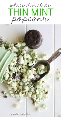 white chocolate peppermin popcorn is in a green cup and on top of it are two spoons