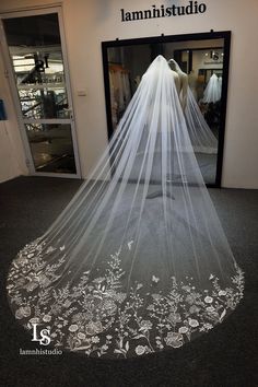 a white wedding veil on display in front of a store