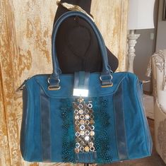 Fabulous Faux Leather And Suede Teal With Silver And Peacock Feather Accents. Faux Leather Has Appearance Of Slight Distressed Look By Design. Comes With Adjustable Shoulder Strap. Zipper Closure. Truly Beautiful Bag. New W/O Tags. Never Used. Bundles-- Shipping Cost Listed Is Up To 5lbs.... Chic Embellished Blue Bag, Chic Blue Embellished Bag, Blue Leather Party Bag, Charming Charlie, Peacock Feather, Beautiful Bags, Leather Satchel, Large Bags, Satchel