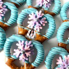 decorated cookies with frosting and flowers on them are arranged in the shape of snowflakes