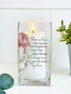 a candle that has been placed in a glass vase with flowers on it and the words, there are love