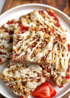 strawberries and granola bars on a plate with white glaze drizzled over them