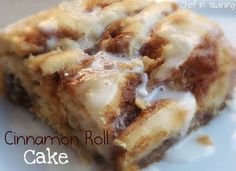 a close up of a piece of food on a plate with the words cinnamon roll cake written below it